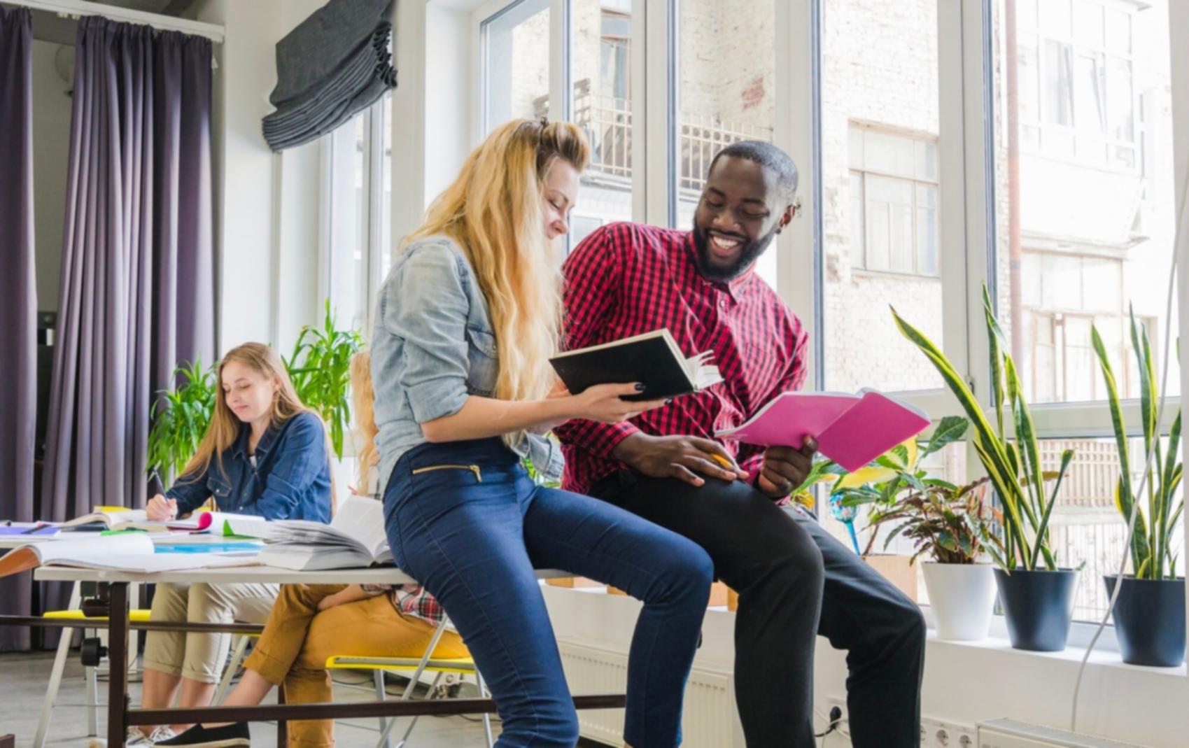 Person reviewing financial planning documents with laptop and notes
